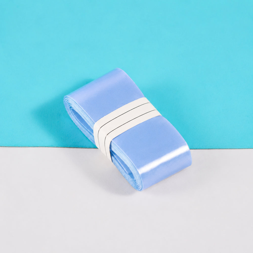 Light blue S1 overgrip roll showing its smooth surface.