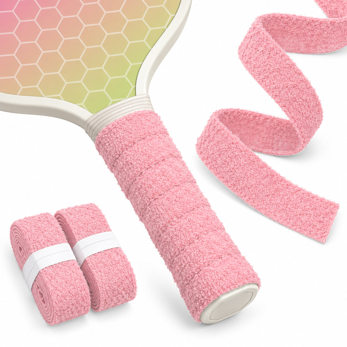Pink T1 towel overgrip on a pickleball paddle handle with matching rolls and a textile strip.